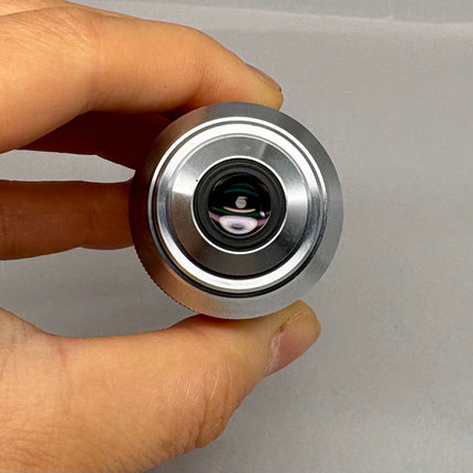 Nikon L Plan EPI CR 50x0.70 ∞/0-1.2 EPI OFN25 MUE35500 Objective lens in hand for microscopy use.