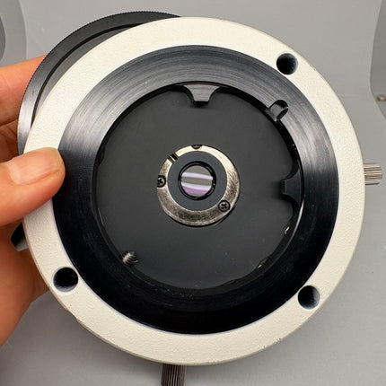 Nikon Pol Microscope P-I Intermediate Tube W/Analyzer-NC W/P-CL Quarter Wave Tint Plate shown from above with hand holding it.
