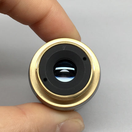 Olympus Objective LMPlan 5X0.10 IR ∞/0 RMS Thread in hand, showcasing the lens and RMS threading.