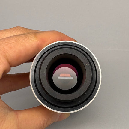Zeiss 2.5x DSLR Camera Adapter Tube 456005 showing the optical lens from a hand perspective.