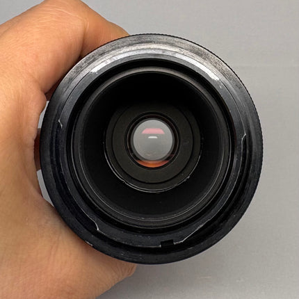 Hand holding the Zeiss 2.5x DSLR Camera Adapter Tube 456005, showcasing the lens opening.