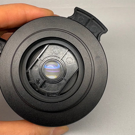 Nikon Microscope C-C Slider Achr NA=0.9 condenser observed from above with colorful lens reflection.